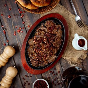 Fried meat slices with pomegranate